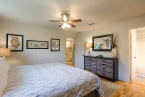 A bedroom with a bed, a dresser, a ceiling fan, and framed artwork on the wall. - 5 bed/5 bath Hiking on Greenbelt Close to Zilker! (Austin)