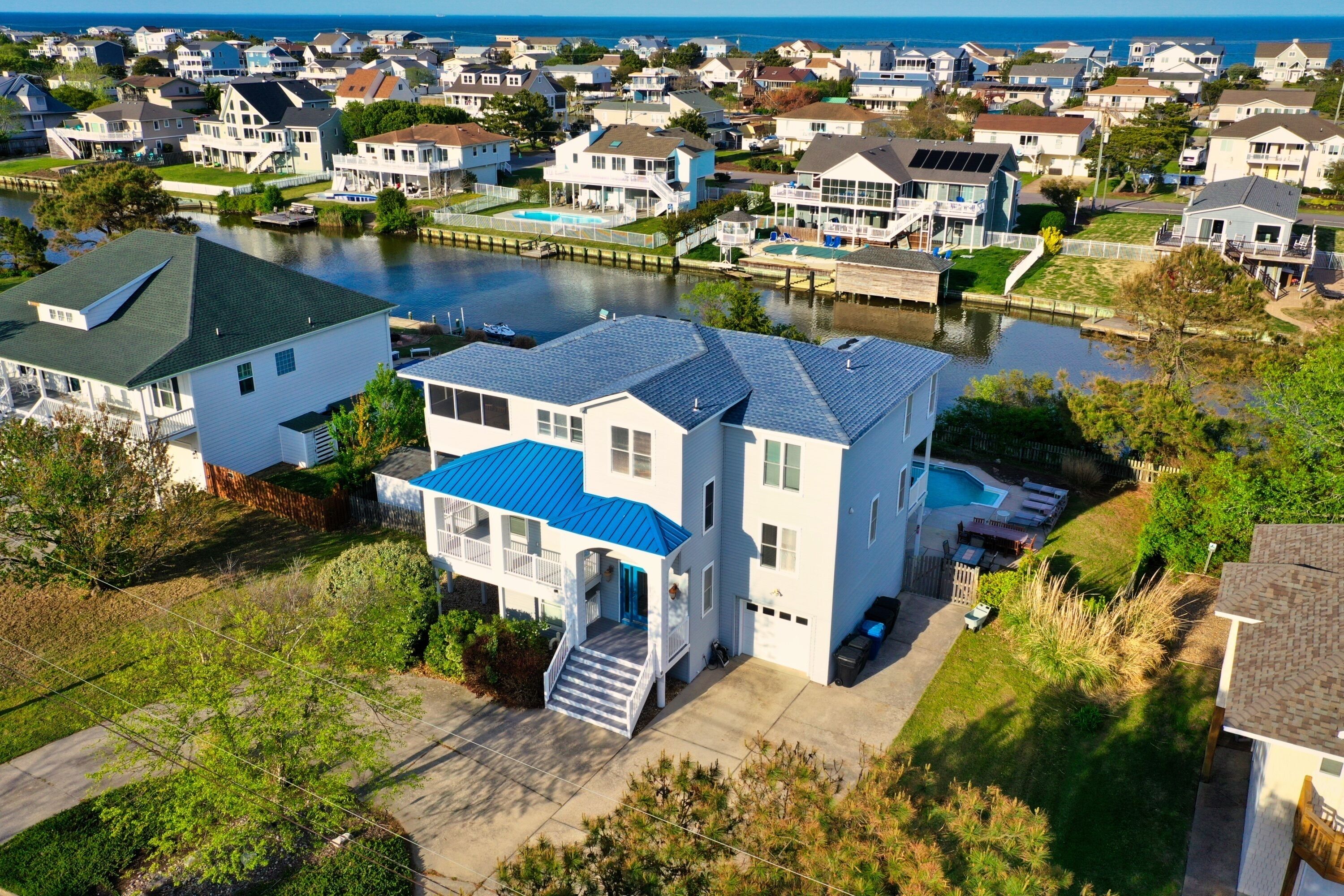 A residential area with houses, a dock, and a body of water.