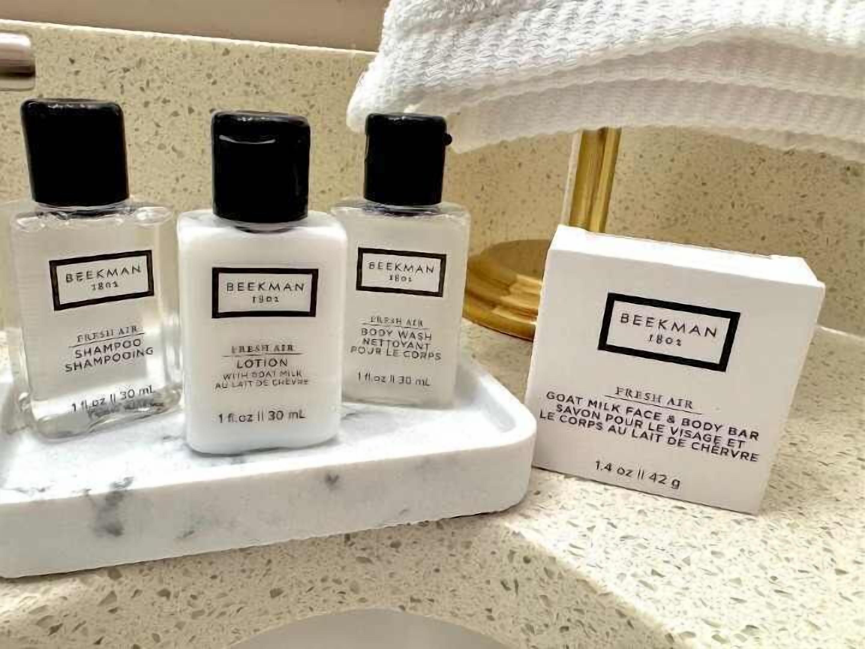 Three bottles of Beekman 1801 fresh air shampoo and lotion, and a box of Beekman 1801 goat milk face & body bar soap.