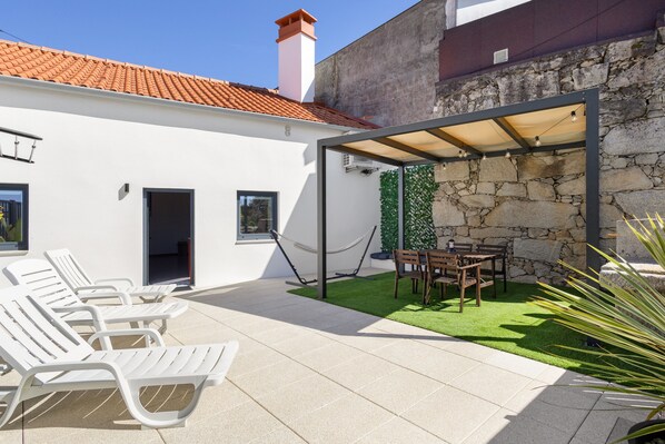 A patio area with outdoor seating and a covered section.