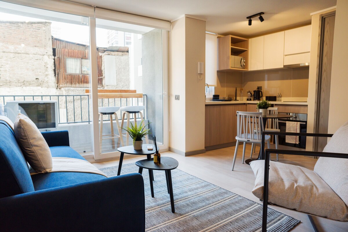 A modern apartment with a balcony, a dining area, and a kitchen.
