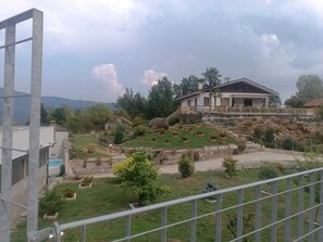 A residential area with a house, a swimming pool, and a landscaped garden.