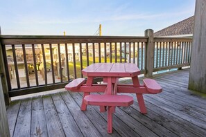 A wooden deck with a picnic table and benches. - Coastal Escape - Beach Access - Pet Friendly (Bolivar Peninsula)