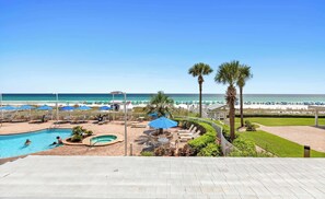 A resort pool area with a view of the beach and ocean. - Oceanfront Condo with Shared Pool & Fitness Room (Destin)