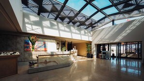 A spacious lobby with a high ceiling, a reception desk, and a large window allowing natural light. - Retac Abu Simbel Nefertari Hotel (Abu Simbel)