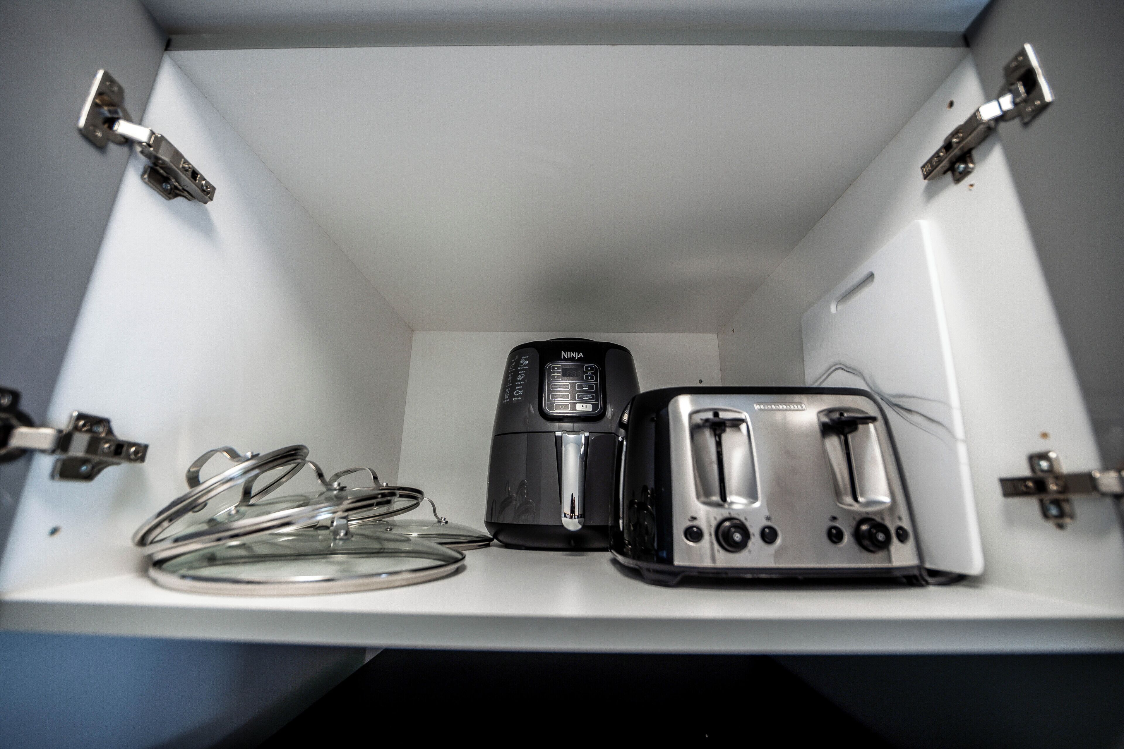 A kitchen with a toaster and a coffee maker on the counter.