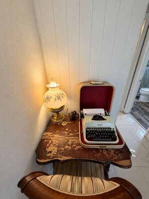 A vintage typewriter on a wooden desk with a lamp, a chair, and a red interior. - Memories!! (Holiday)