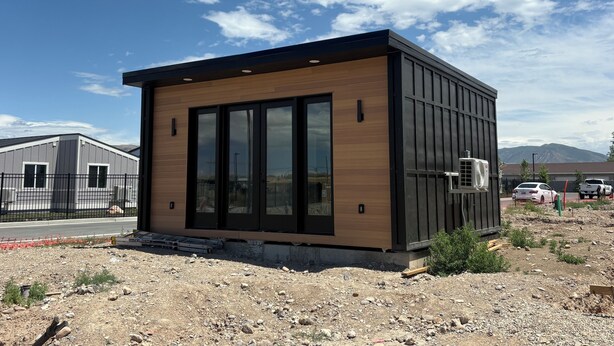A modern building with large windows and a flat roof.