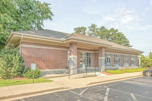 A brick building with a covered entrance, large windows, and a parking lot. - The Delton Grand 403 (Wisconsin Dells)