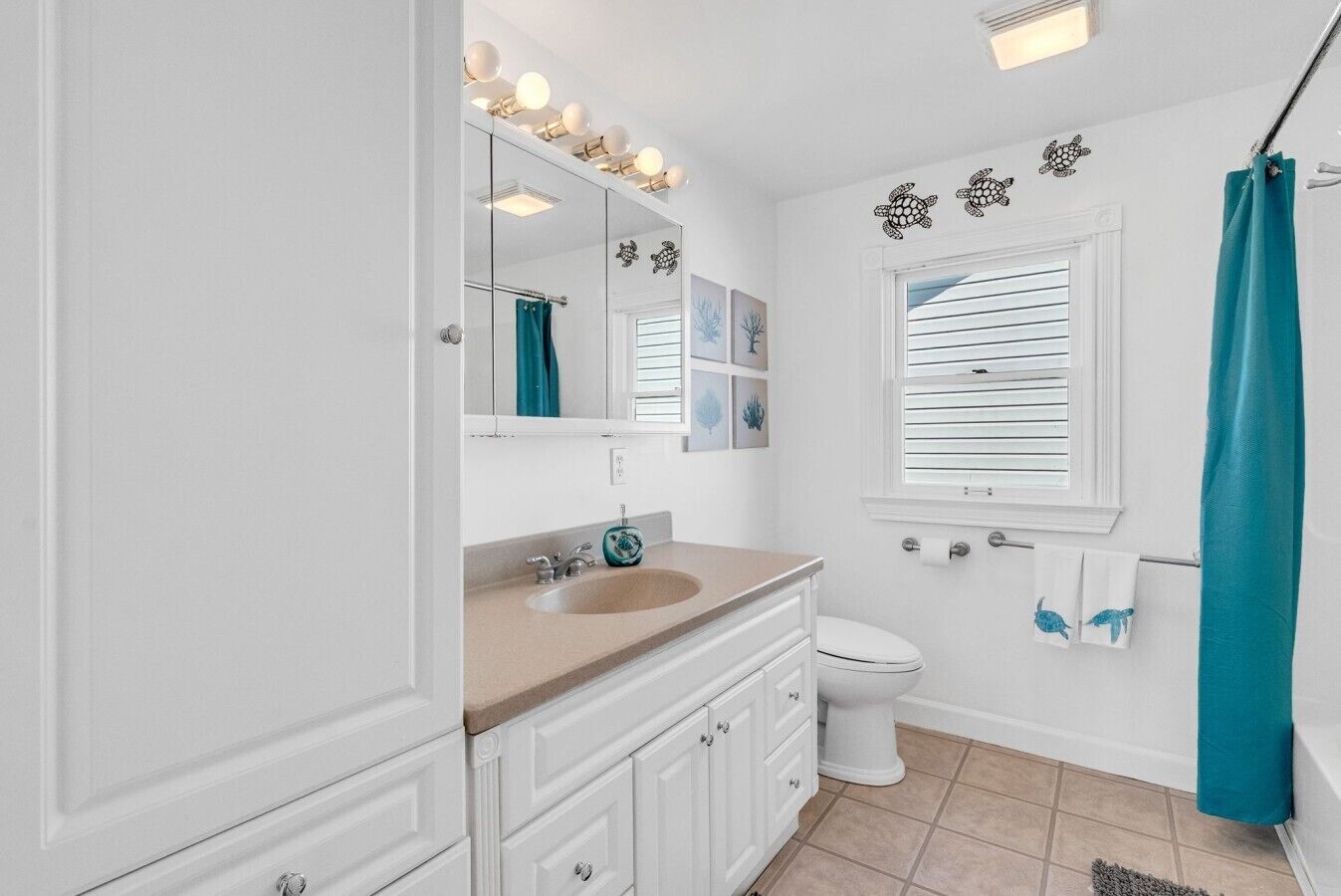 A bathroom with a sink, mirror, and toilet.