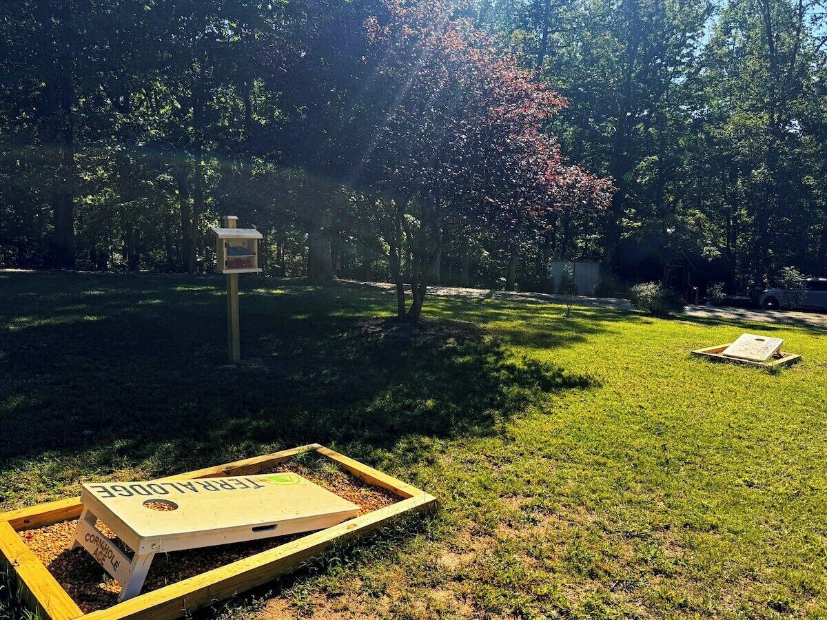 A grassy outdoor area with a wooden structure labeled 'FRAGILE' and a signpost.