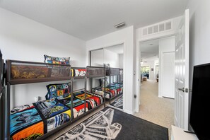 A corridor with bunk beds, each with a Star Wars themed bedspread. - 15min from Disney - Spacious Starwars themed condo (Kissimmee)