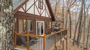A cabin with a deck, a grill, and a dining table. - Cozy Masthope Chalet on 2 Private Wooded Acres w/ Grill, Fire Pit & Pet-Friendly (Lackawaxen)