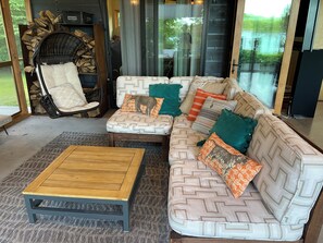 A cozy living area with a sofa, a chair, and a coffee table. - Stunning 6-bedroom modern lake house perfect for families (Erhard)