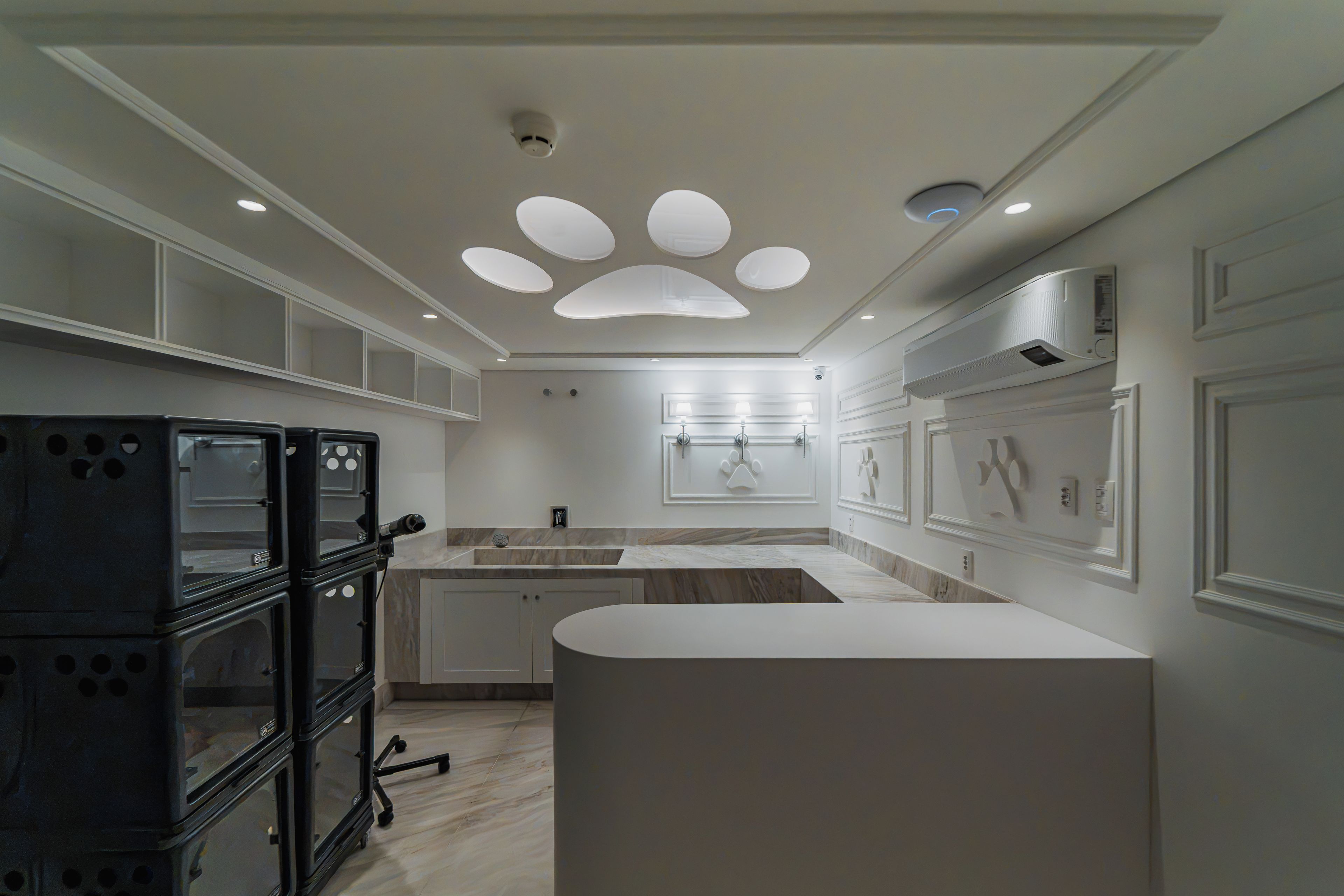 A modern kitchen with a central island, pendant lighting, and a built-in stove.