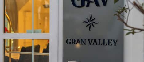 A sign with 'GAV GRAN VALLEY' on a building's exterior wall.