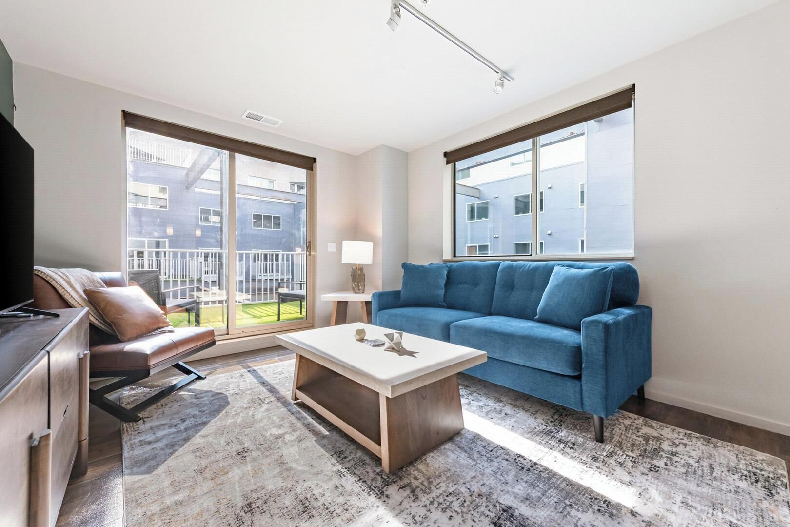 A modern living room with a sofa, coffee table, and TV.