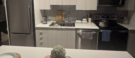 A modern kitchen with stainless steel appliances, a microwave, and a dishwasher.