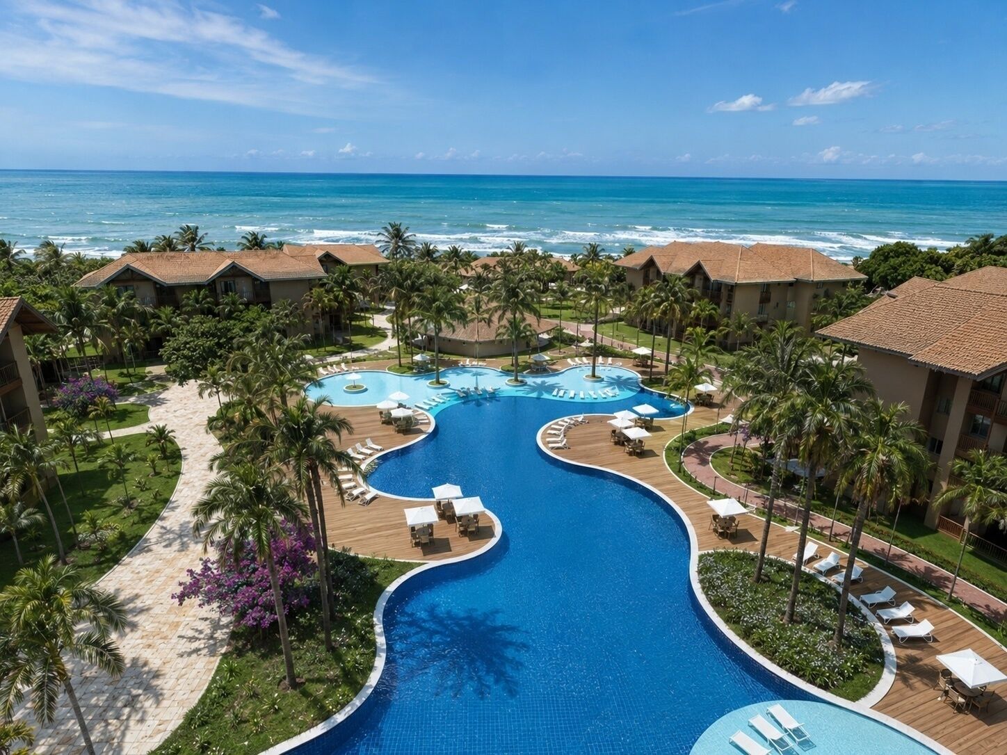 Resort-style pool oasis with palm trees and sweeping ocean views
