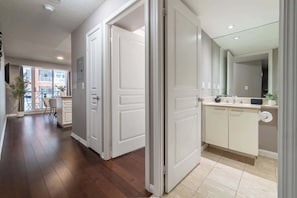 A modern apartment interior with a kitchen, dining area, and a view of a balcony. - Trendy Retreat Chic 2BR Suite Near City Sights (Toronto)