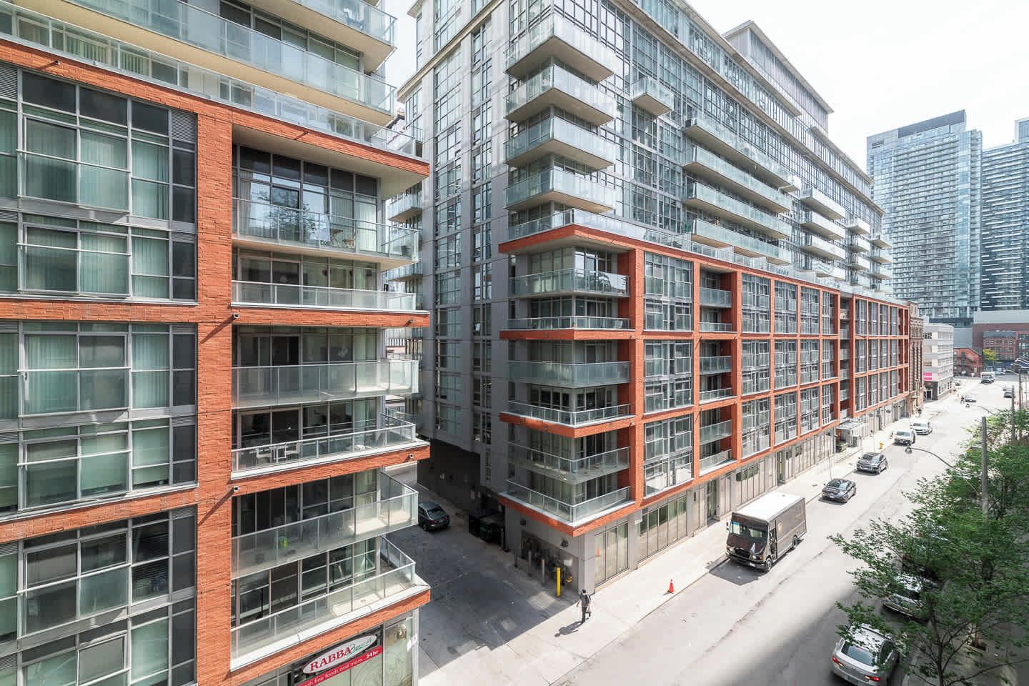 A multi-story building with a modern architectural design, featuring large windows and balconies.