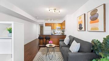A modern apartment with a kitchen, dining area, and living room.