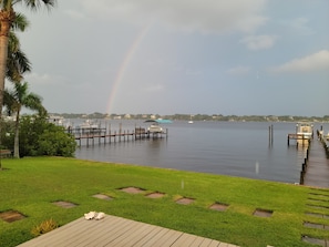 A waterfront property with a dock, boats, and a grassy area. - Historic 4-bedroom/2 bath house on St Lucie River-Big Water Views (Stuart)
