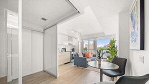 A modern apartment with a kitchen, dining area, and living room. - City Living Downtown Retreat Perfect Getaway! (Toronto)