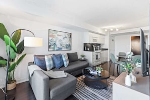 A modern living room with a sofa, coffee table, and artwork. - Downtown Central - Rogers Centre - 3 beds - Views (Toronto)