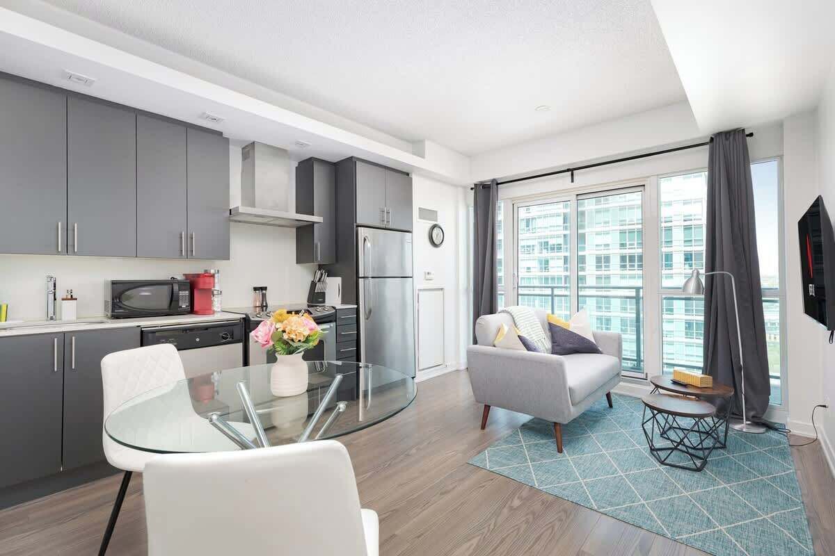 A modern apartment with a kitchen, dining area, and living room.