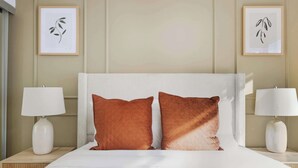 A hotel room with a large bed, two pillows, two bedside lamps, and two framed artworks on the wall. - Modern 1BR Suite Steps to Subway City Views! (Toronto)