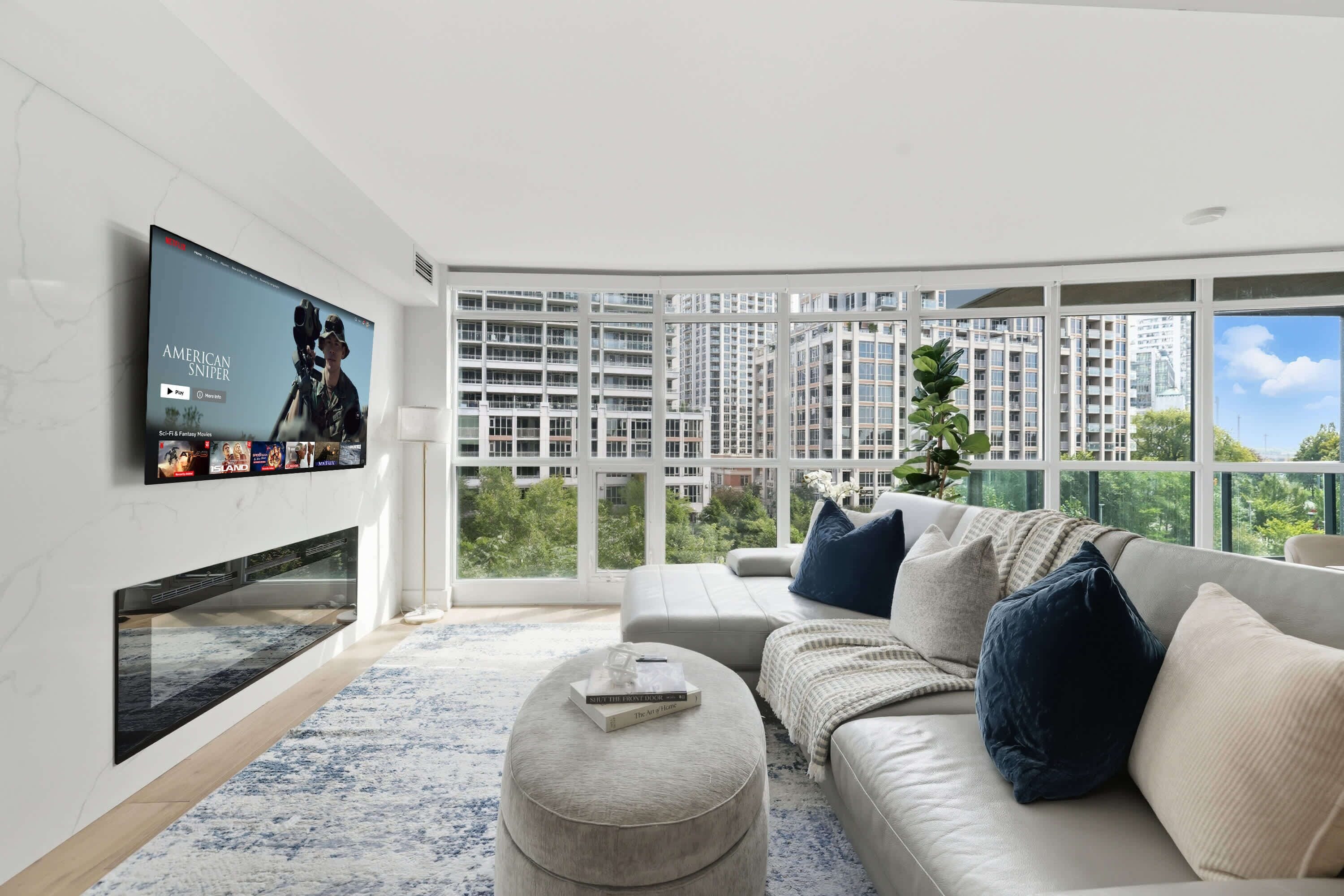 A modern living room with a flat-screen TV, a sofa, and a large window offering a city view.