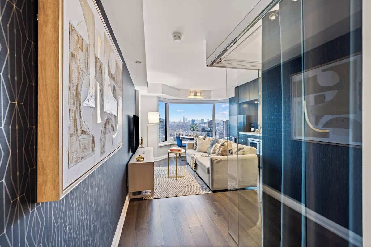 A modern living room with a city view, a sofa, a coffee table, and a side table.