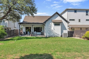 A residential property with a covered patio, a fenced backyard, and a two-story building. - Skier's Cove - Lake Access & Deeded Boat Slip (Granite Shoals)