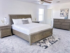 A bedroom with a bed, nightstands, a dresser, a ceiling fan, and a window. - Prime North Scottsdale Retreat Near Golf, Hiking, Shops, Dining & Loop 101 (Scottsdale)