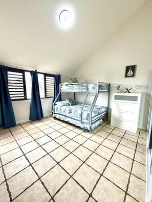 A room with a bunk bed, a dresser, and a window with curtains. - 2-Story Beachfront Penthouse Steps to the Sand (Palmas del Mar)