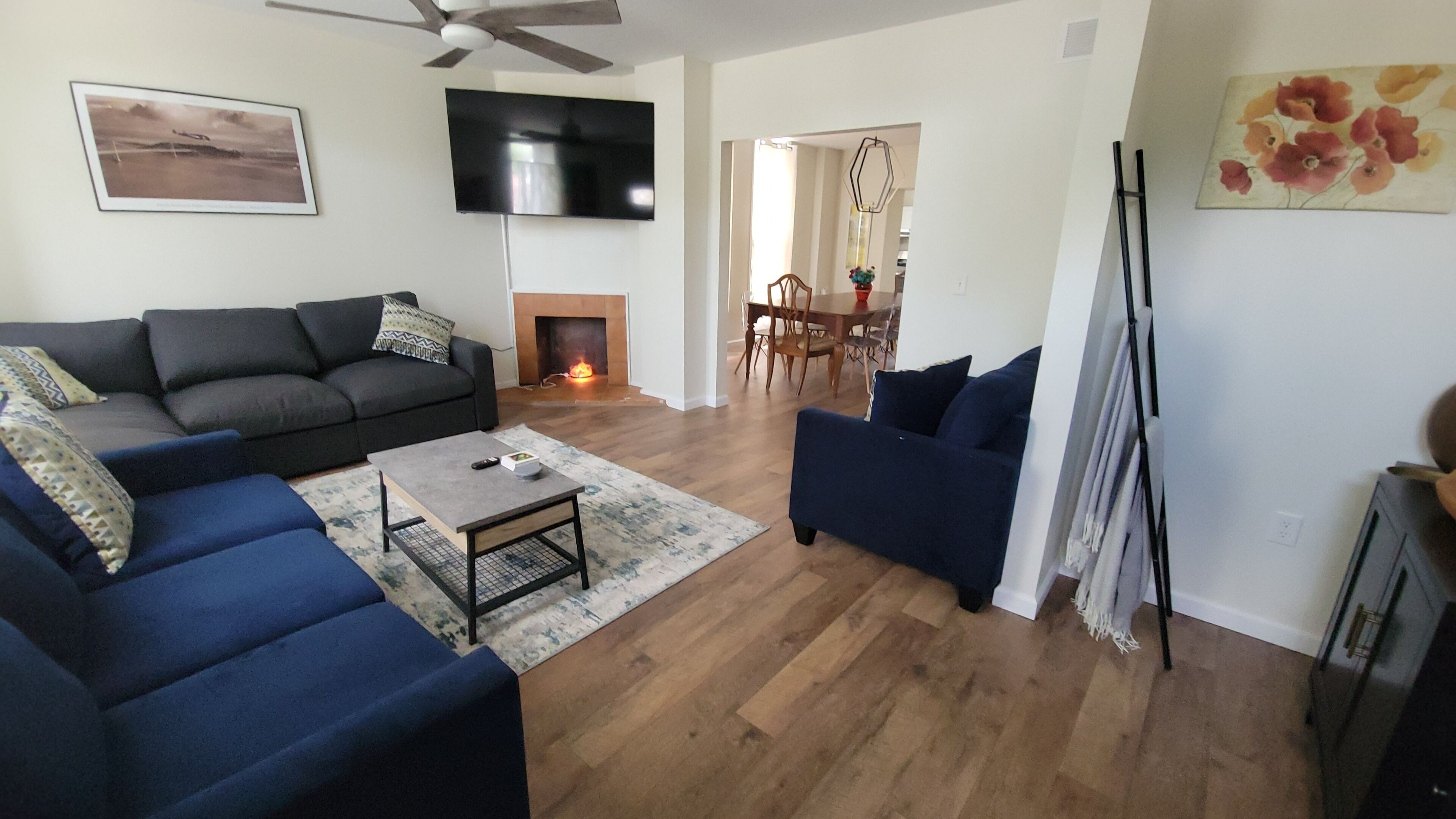 A living room with a sofa, a coffee table, and a TV.