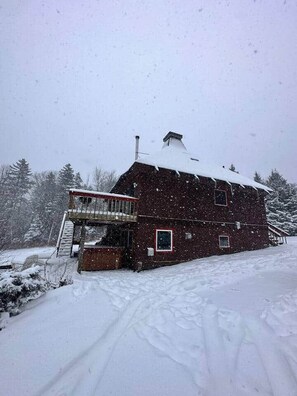 A snow-covered wooden cabin with a balcony, surrounded by snow-covered trees. - MtSnow* HotTub*  Pool * AirHockey*PingPong * Darts (Wilmington)
