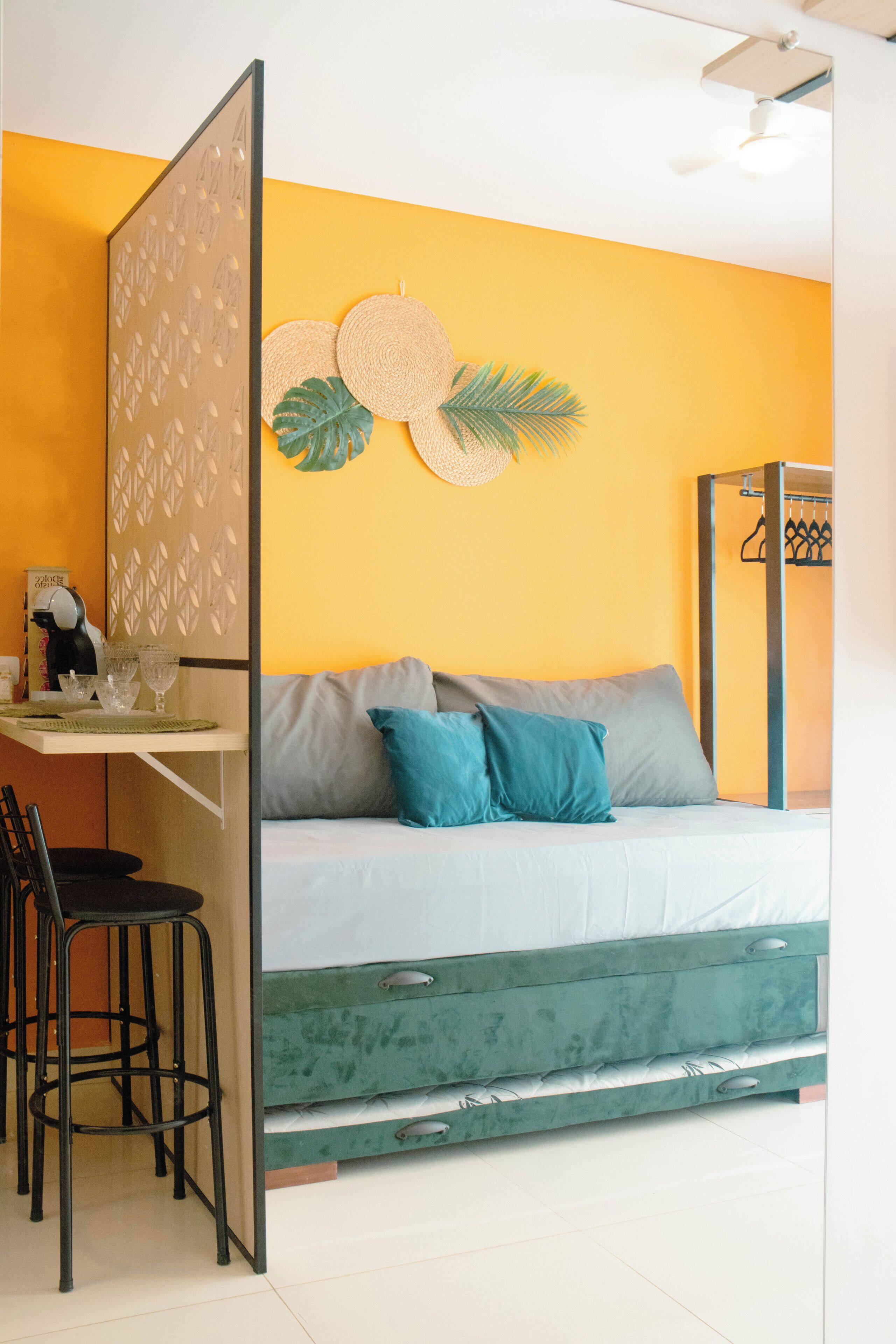 A room with a bed, a desk, and a chair.