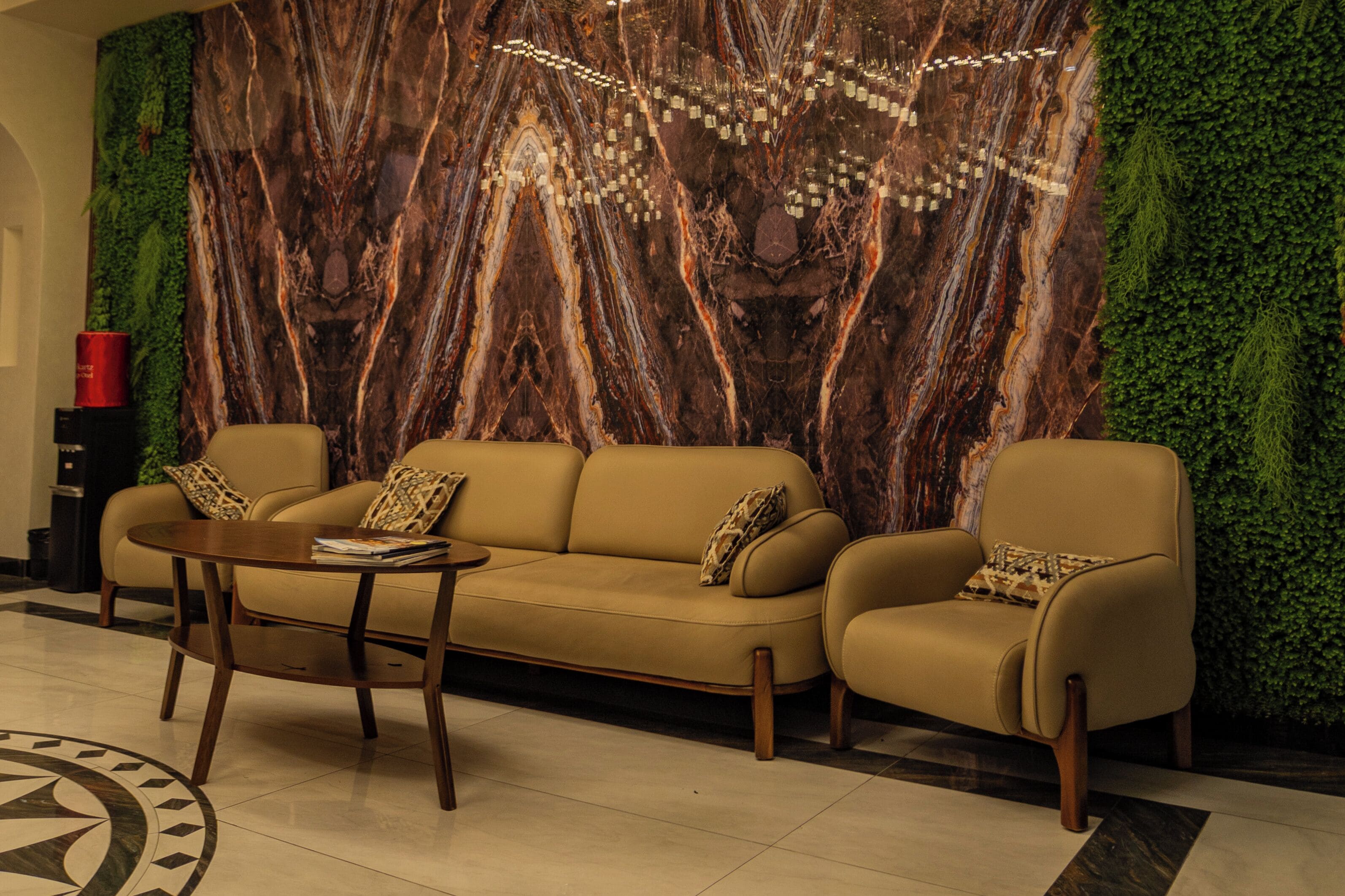 A lobby with a sofa set, a small table, and a patterned floor.