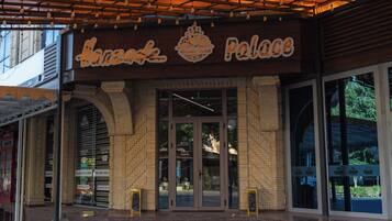 A building with a sign that reads 'Hanzade Palace' and a brick facade.