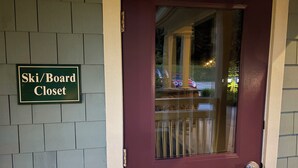 A door with a sign reading 'Ski/Board Closet' and a window with a view of parked cars and trees. - SMUGGLERS NOTCH. Ski in/ski out. Popular  ski retreat.Stay onsiteSki Lift access (Jeffersonville)