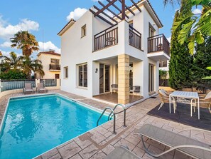 A two-story house with a swimming pool, outdoor seating, and a balcony. - Villa Amara, Protaras | Private Pool (Protaras)