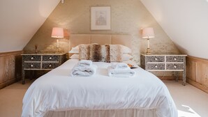 A bedroom with a large bed, two nightstands, a headboard, and a framed picture on the wall. - The Old Forge - Stanton, Broadway (Stanton, nr Broadway)