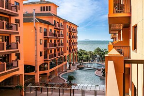 A multi-story hotel with balconies, a swimming pool, and a view of the sea. - Suite W/beautiful View in Resort in Jurere Jbv252 (Florianópolis)