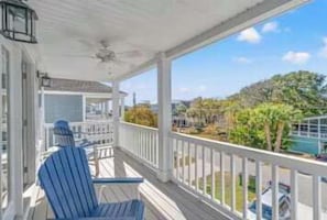 A covered porch with a view of a pool and trees. - Sleeps 36, 12 BR 12 BA, 2 Pools, New Build, 118AB (Surfside Beach)