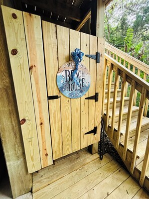 A wooden door with a sign that reads 'Welcome to the Beach House.' - The Tree House (Atlantic Beach)
