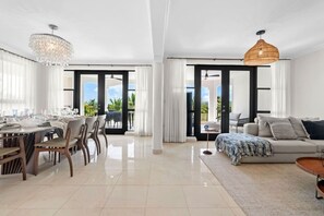 Thoughtfully designed space for shared meals and long conversations. - Luxury Oceanview Condo | Hyatt PR Golf & Beach (Rio Grande)
