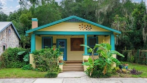 A single-story house with a gabled roof, a front porch, and a small front yard. - Gville and Chill House (Gainesville)