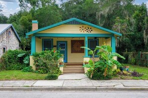 A single-story house with a gabled roof, a front porch, and a small front yard. - Gville and Chill House (Gainesville)